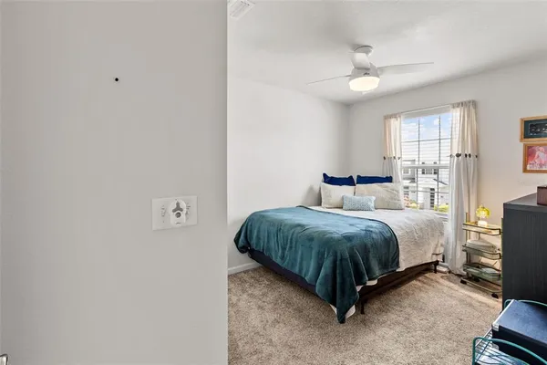 a spacious bedroom with a bed and window