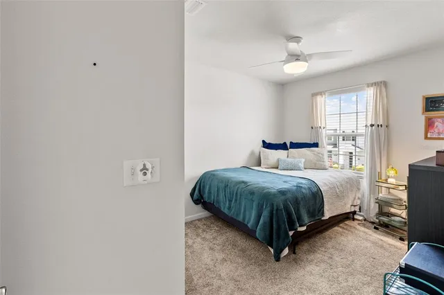 a spacious bedroom with a bed and window