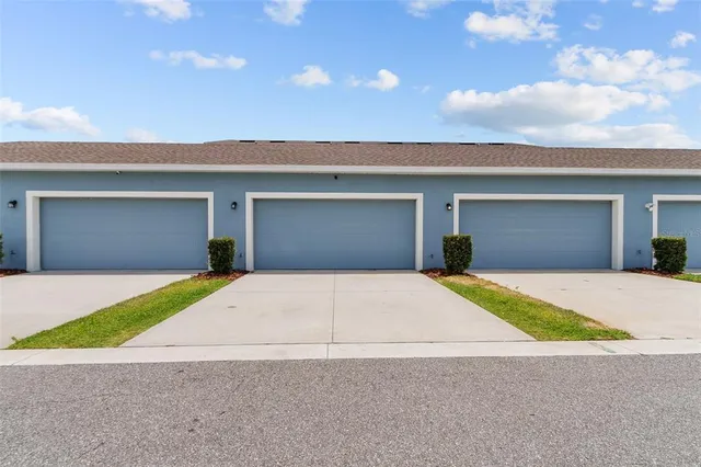 a front view of a house with a garage and a garage
