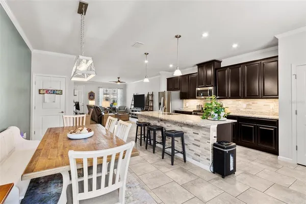 a kitchen with a table chairs microwave and stove