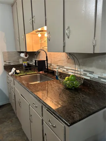 a kitchen with a sink and a stove