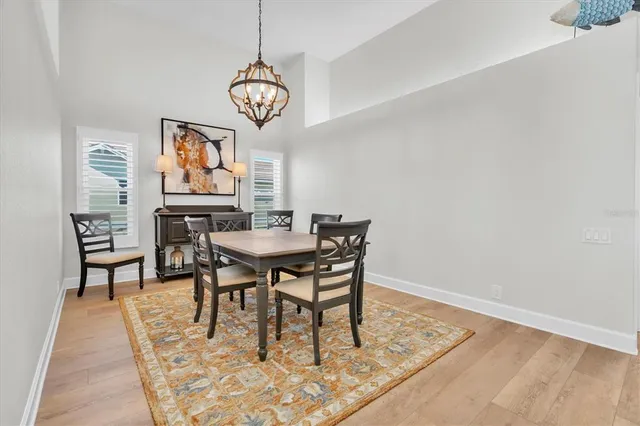 a dining room with furniture a rug and wooden floor