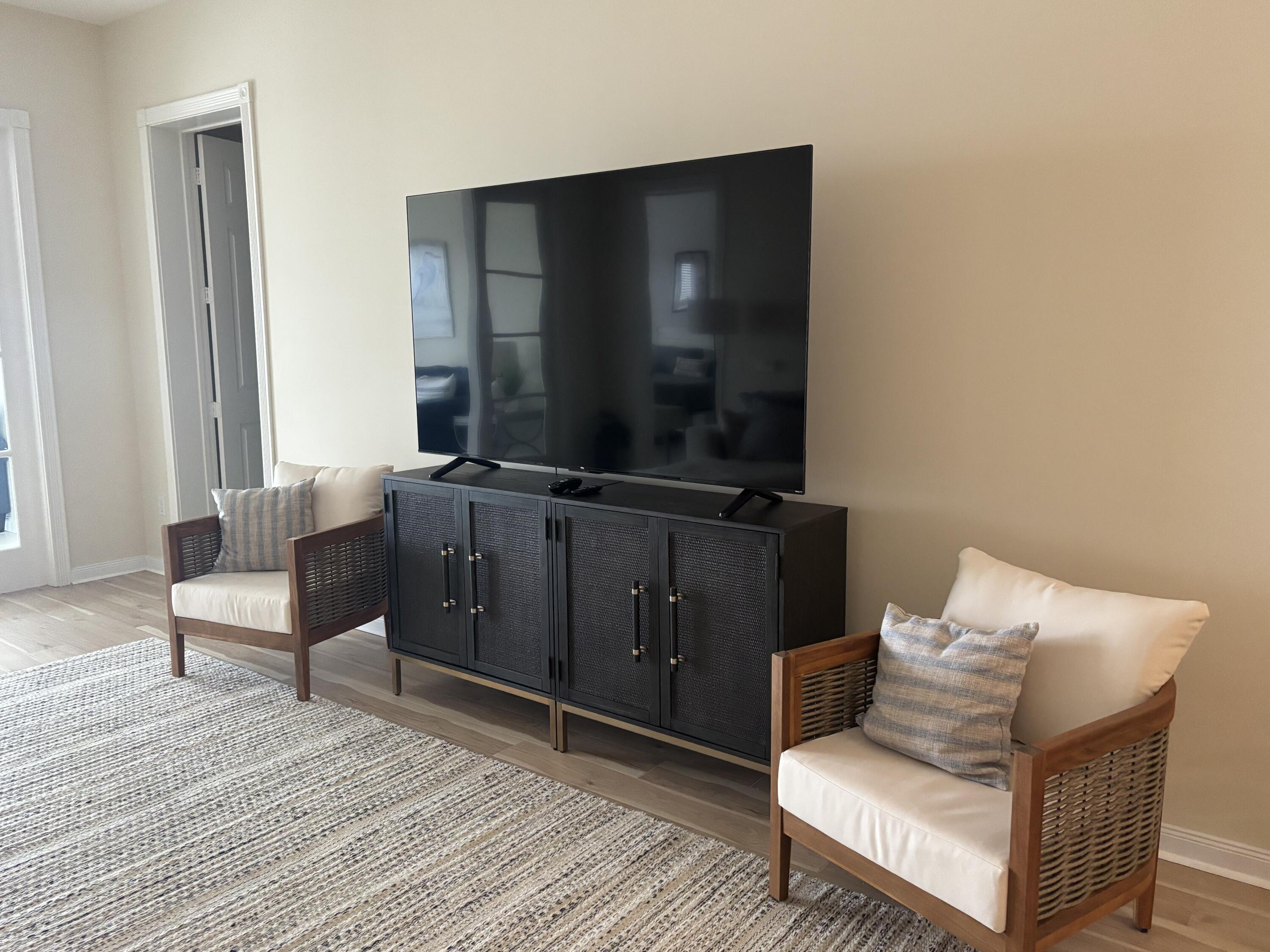 38 Harbour Isle Drive East, Unit PH01 Fort Pierce, FL 34949 - Photo 11 of 30 a living room with furniture and a flat screen tv