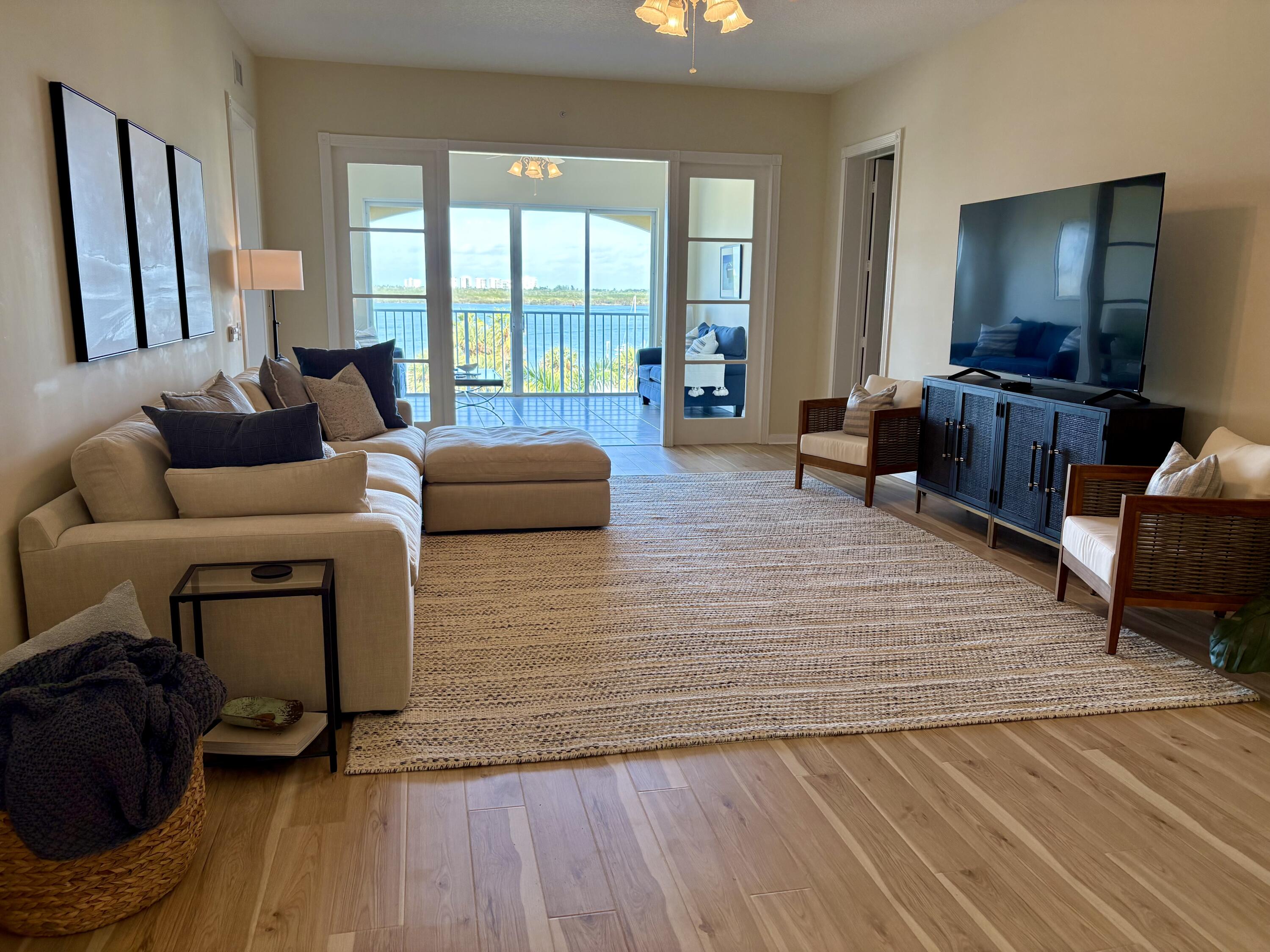 38 Harbour Isle Drive East, Unit PH01 Fort Pierce, FL 34949 - Photo 13 of 30 a living room with furniture and a flat screen tv