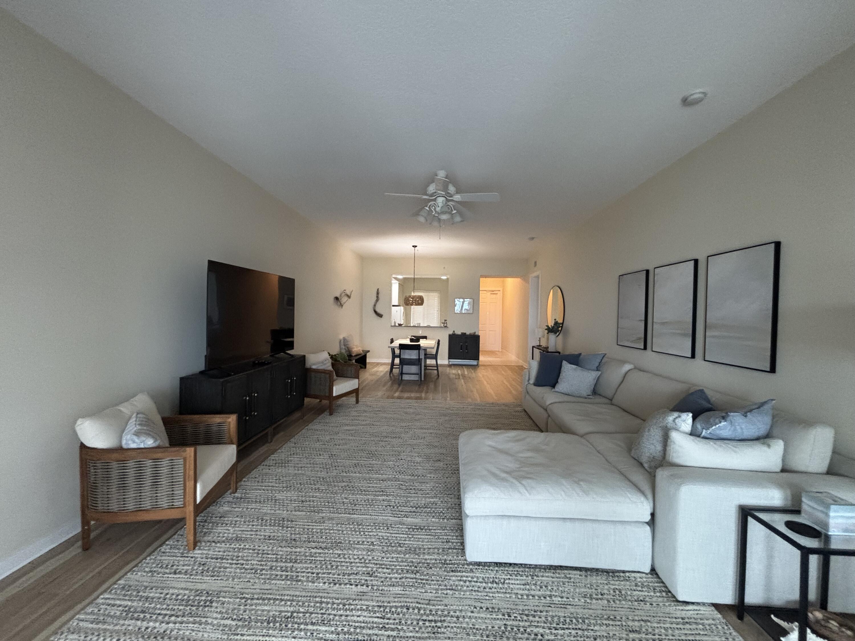 38 Harbour Isle Drive East, Unit PH01 Fort Pierce, FL 34949 - Photo 15 of 30 a living room with furniture and a flat screen tv