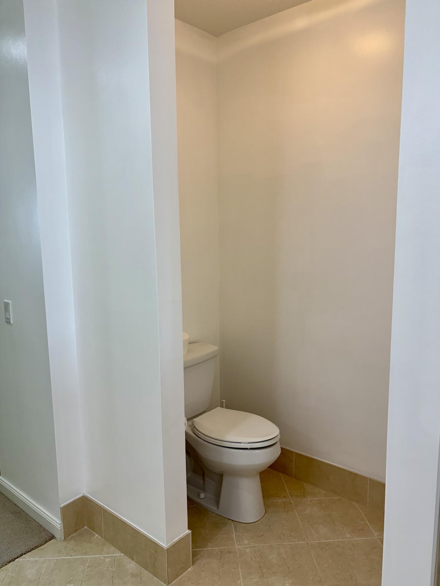 38 Harbour Isle Drive East, Unit PH01 Fort Pierce, FL 34949 - Photo 18 of 30 a white toilet sitting next to a white wall
