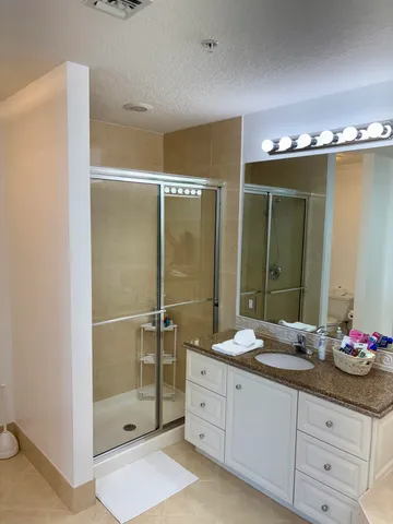 a bathroom with a double vanity sink and a mirror