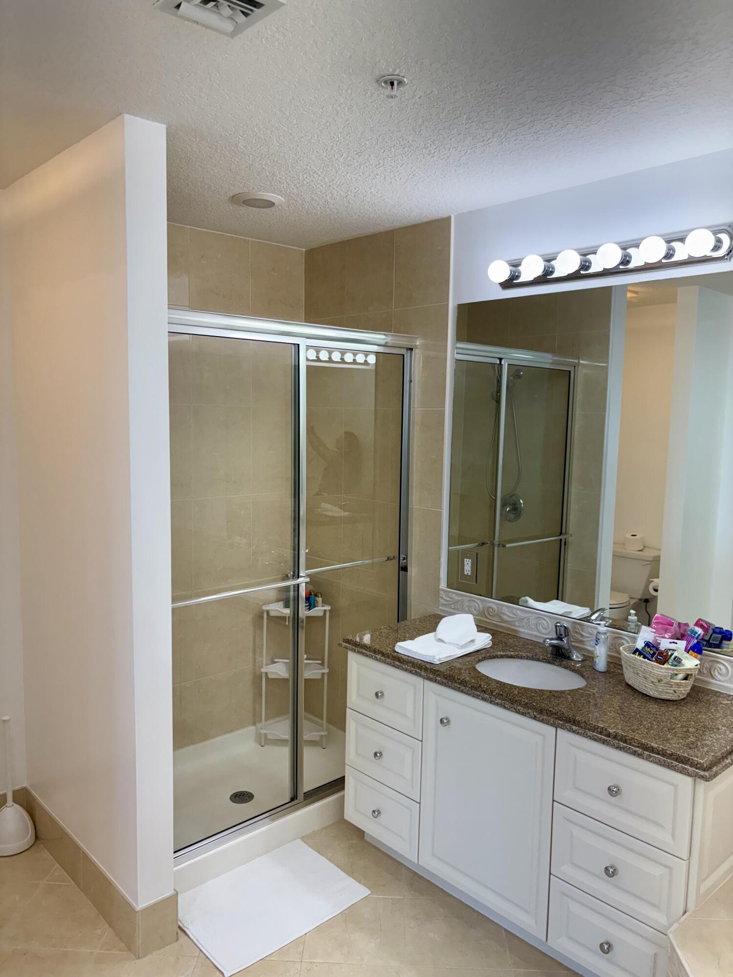 38 Harbour Isle Drive East, Unit PH01 Fort Pierce, FL 34949 - Photo 19 of 30 a bathroom with a double vanity sink and a mirror