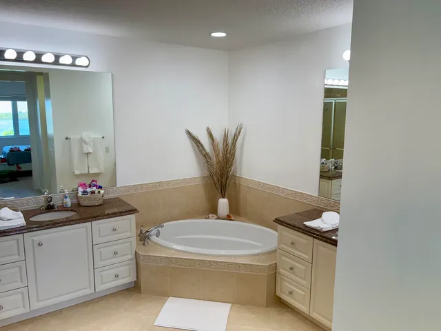 a bathroom with a granite countertop toilet sink and mirror
