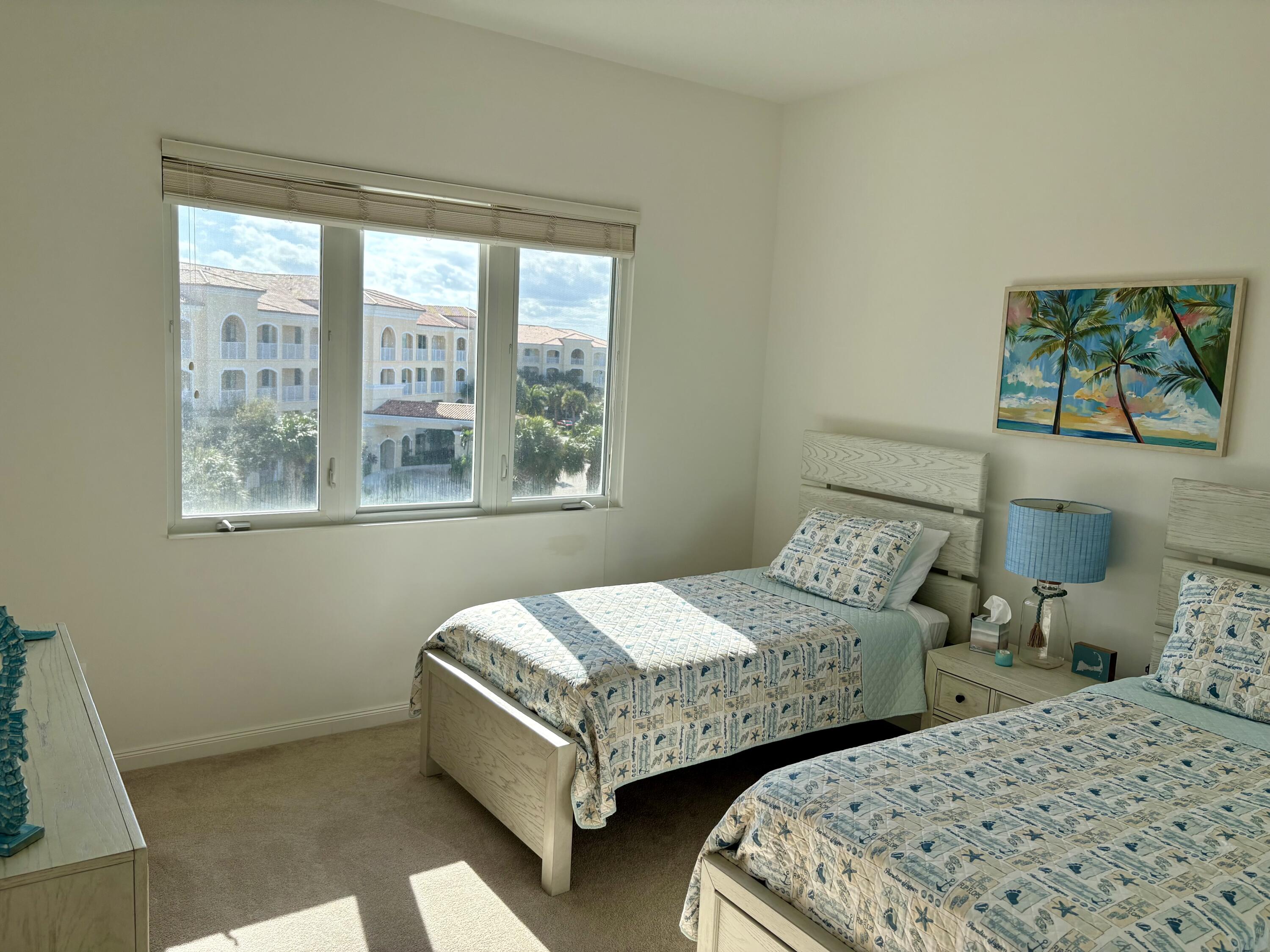 38 Harbour Isle Drive East, Unit PH01 Fort Pierce, FL 34949 - Photo 25 of 30 a bedroom with two beds and a window