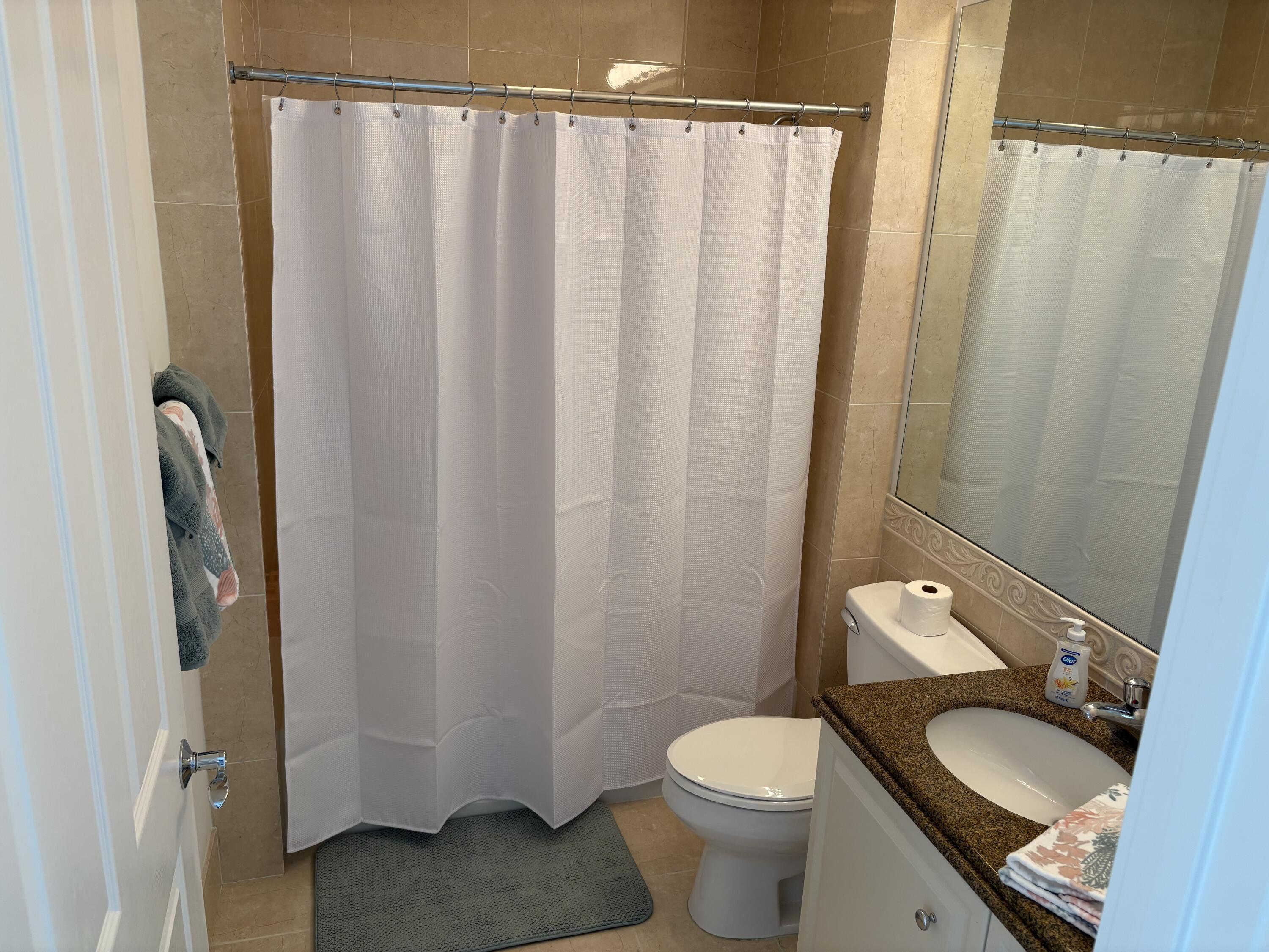 38 Harbour Isle Drive East, Unit PH01 Fort Pierce, FL 34949 - Photo 27 of 30 a bathroom with a granite countertop sink and a mirror