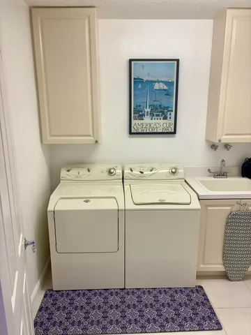 a utility room with a sink dryer and washer