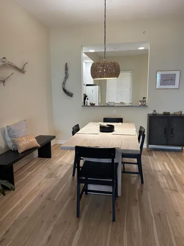 a view of a dining room with furniture wooden floor and chandelier
