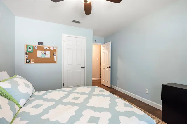 a bedroom with a bed and cabinets