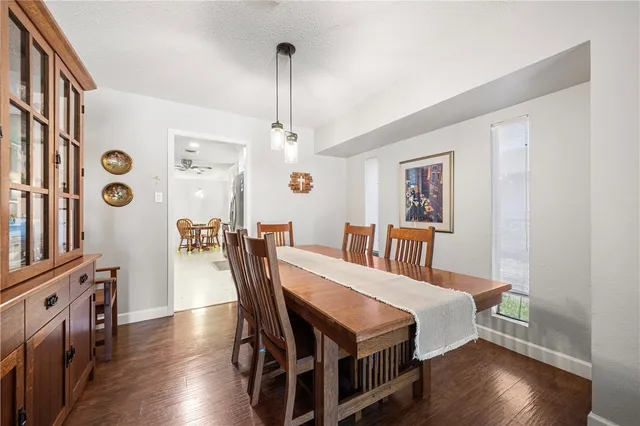 a view of a dining room with furniture and wooden floor