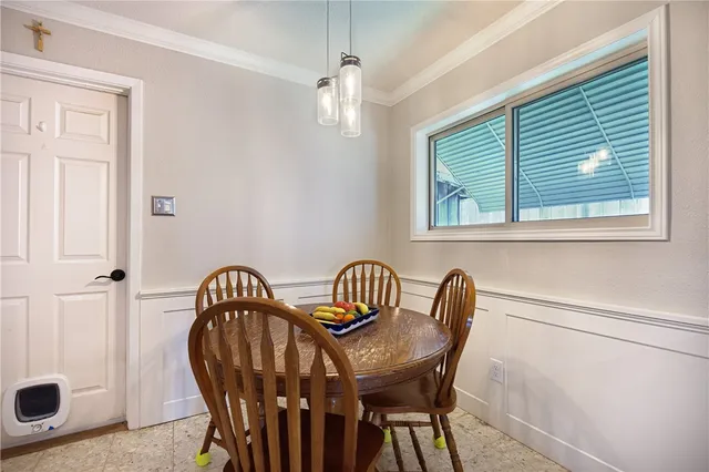 a view of a dining room with furniture and window