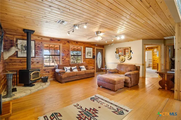 a view of a dining room with furniture a chandelier and wooden floor