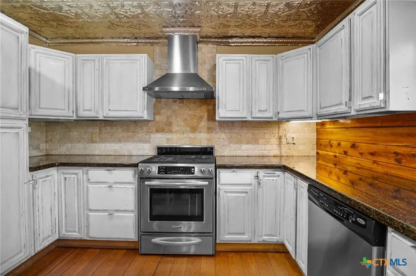 a kitchen with a sink and a stove