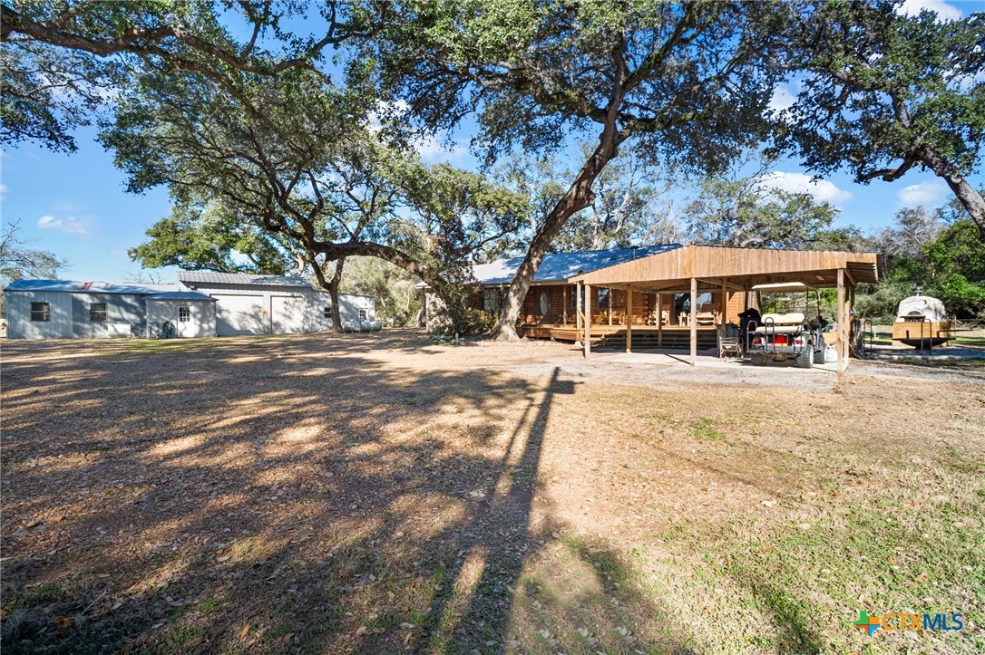 1465 County Road 401 Edna, TX 77957 - Photo 2 of 46 a view of street with houses and trees in the background