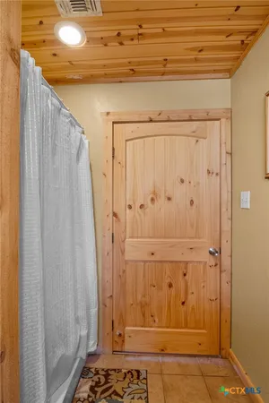 a large bed sitting in a bedroom next to a window