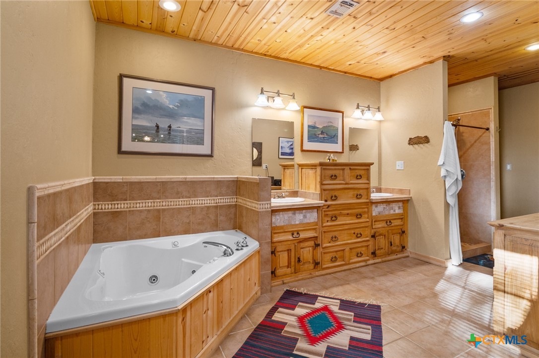 1465 County Road 401 Edna, TX 77957 - Photo 26 of 46 a bathroom with a tub sink and a shower