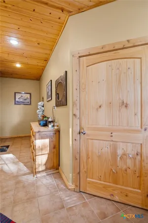 a bed sitting in a spacious bedroom next to a window