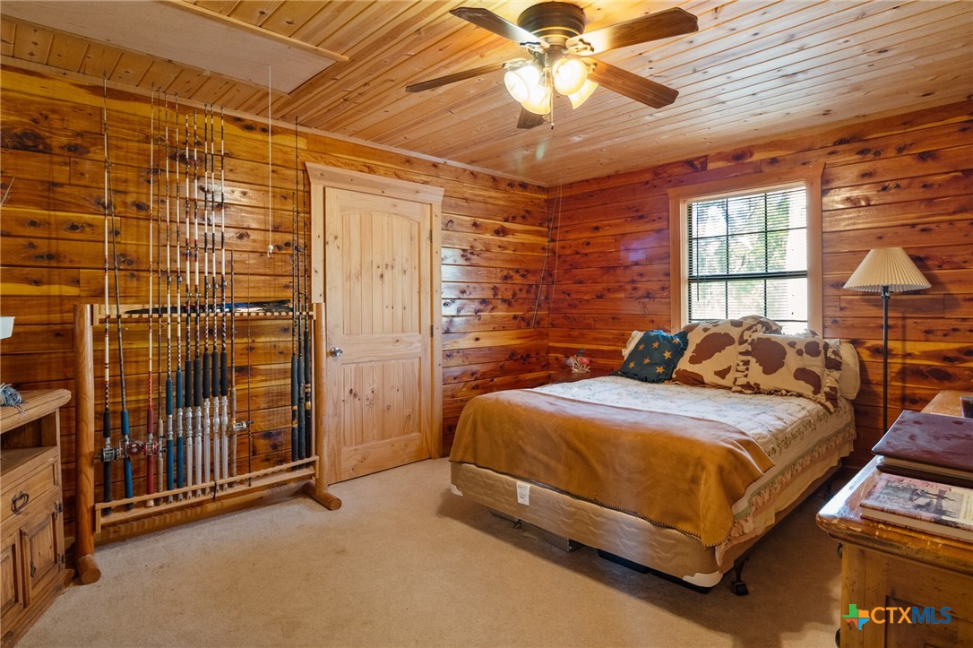 1465 County Road 401 Edna, TX 77957 - Photo 29 of 46 a bed sitting in a spacious bedroom next to a window