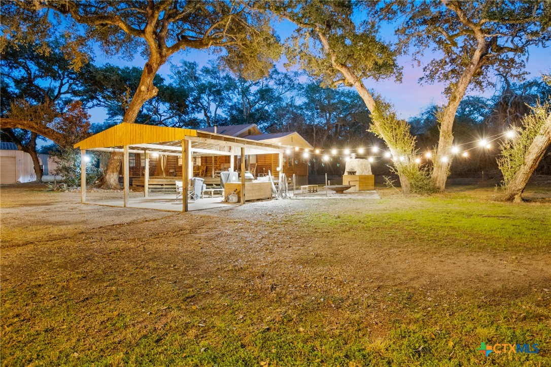 1465 County Road 401 Edna, TX 77957 - Photo 31 of 46 a backyard of a building with swimming pool and large trees