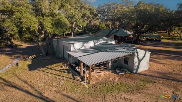a view of a yard with wooden fence