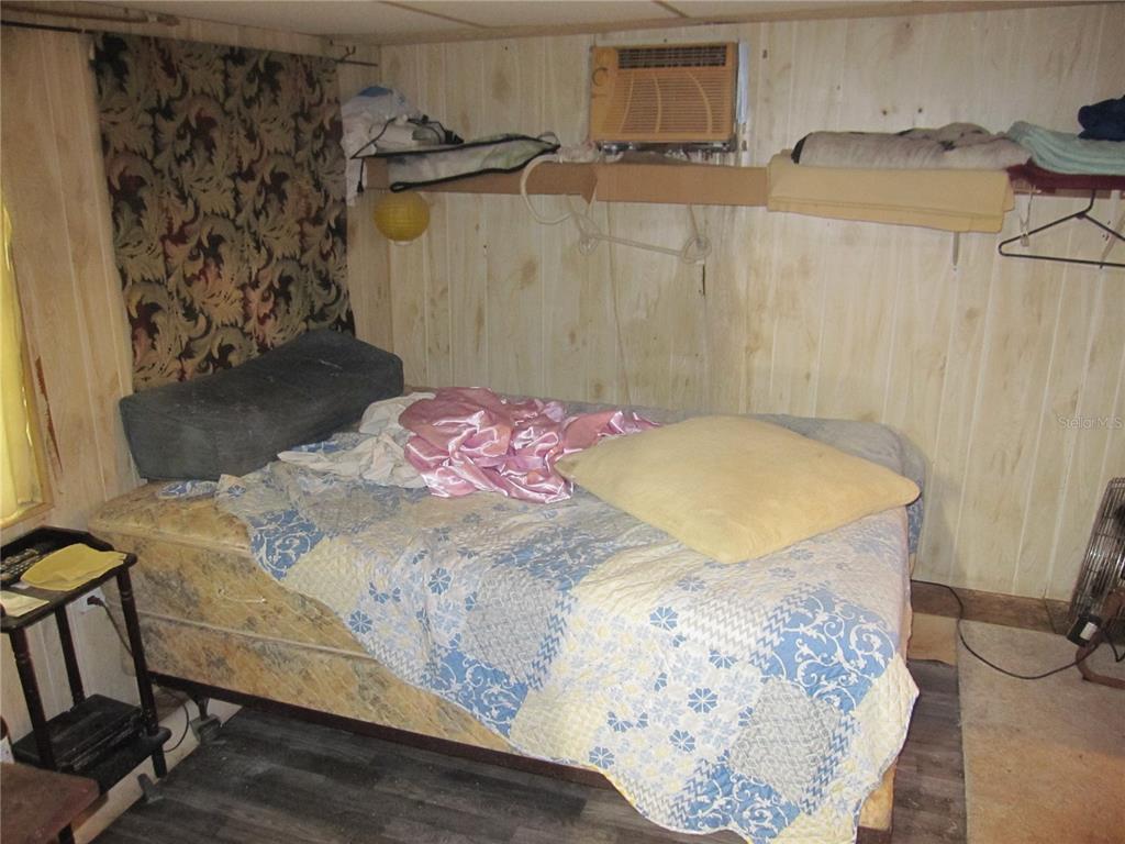 37736 Phelps Road Zephyrhills, FL 33541 - Photo 13 of 30 a bedroom with a bed and a dresser