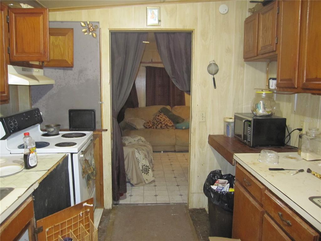 37736 Phelps Road Zephyrhills, FL 33541 - Photo 19 of 30 a kitchen that has a sink and a stove
