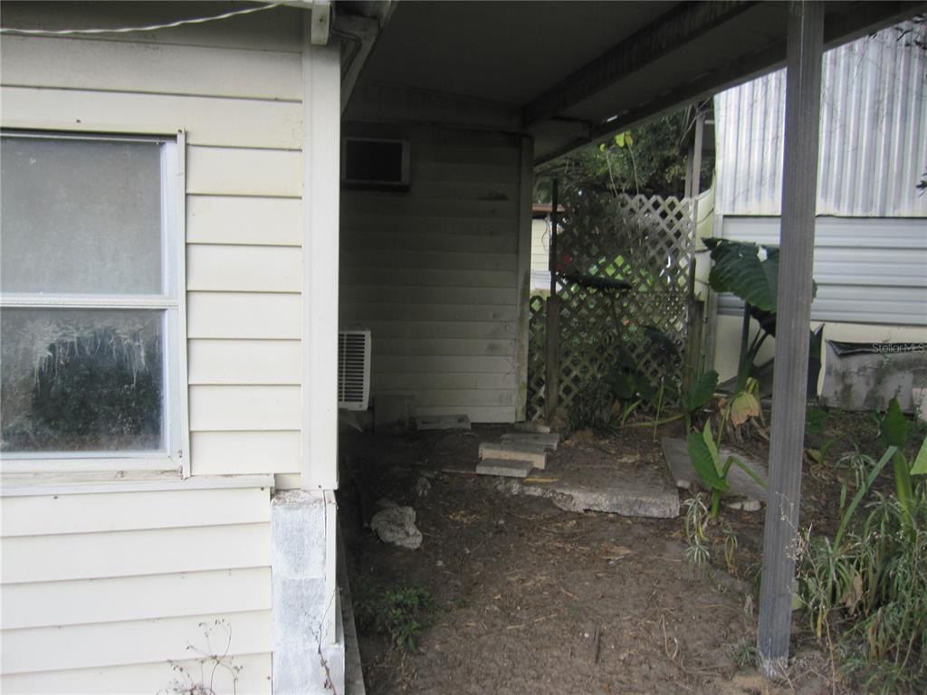 37736 Phelps Road Zephyrhills, FL 33541 - Photo 8 of 30 a view of house with a door and wooden walls
