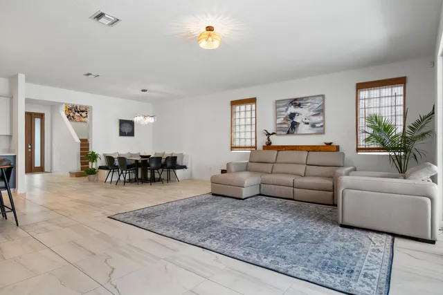 a living room with furniture and wooden floor