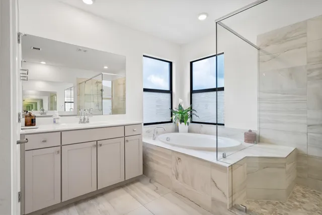 a spacious bathroom with a double vanity sink and a bathtub