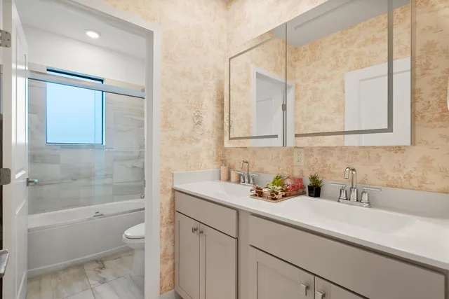 a bathroom with a sink a toilet and bathtub