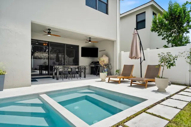 a kitchen with a sink a counter and chairs