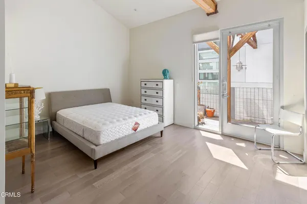 a bedroom with a bed and a large window