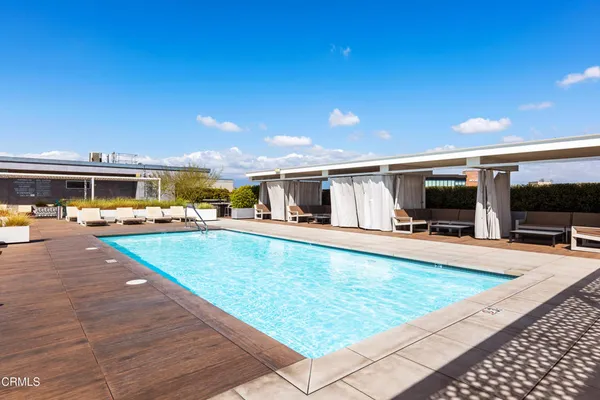 a swimming pool with outdoor seating and yard