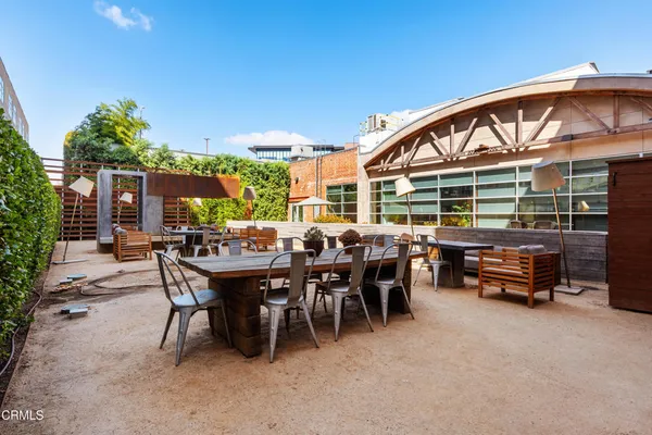 a view of a patio with dining table and chairs