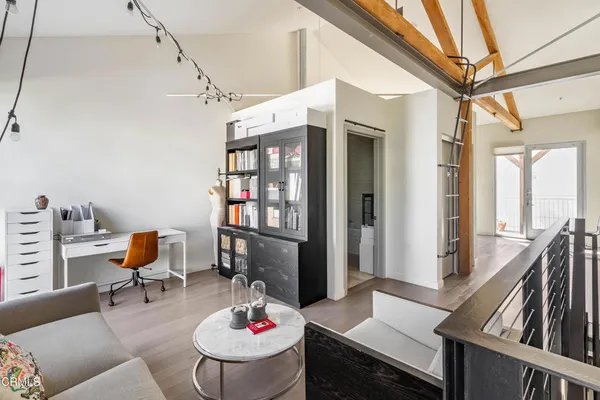 a living room with furniture and a book shelf