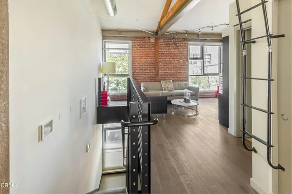 a living room with furniture a window and wooden floor