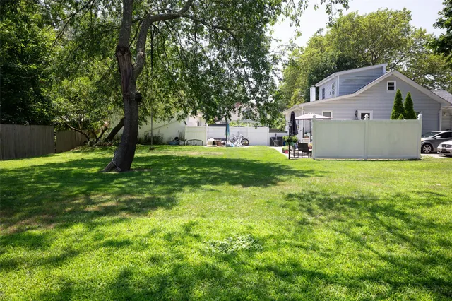 a view of a house with a yard and sitting area