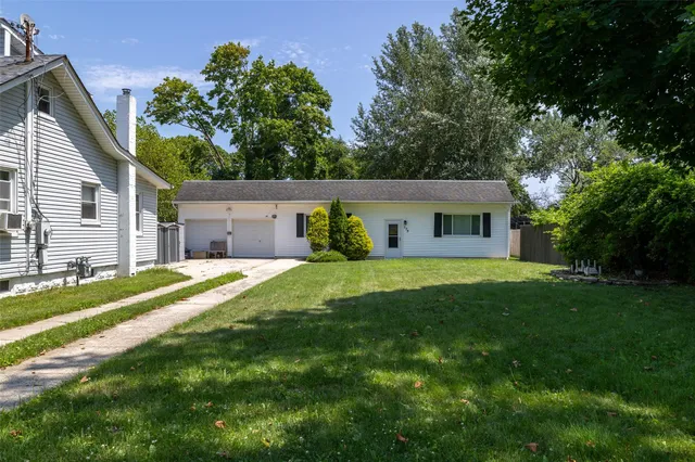 a view of a house with a backyard