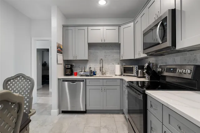 a kitchen with stainless steel appliances granite countertop a sink and cabinets