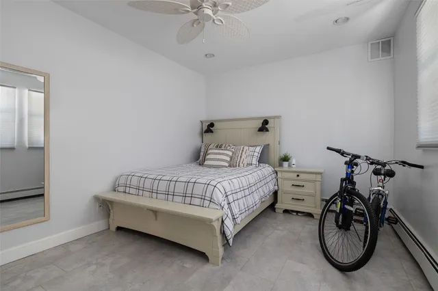 a bedroom with a bed a mirror and a table