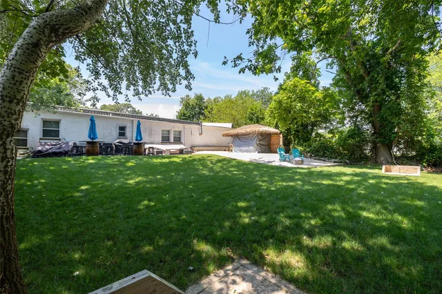 a view of a house with a yard porch and sitting area