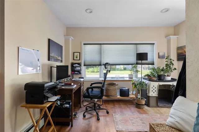 a view of a workspace with a window and sitting area