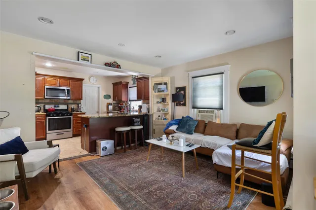 a living room with furniture kitchen view and a fireplace