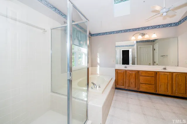 a spacious bathroom with a double vanity sink and a mirror