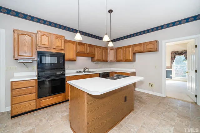 a kitchen with stainless steel appliances granite countertop a stove and a refrigerator
